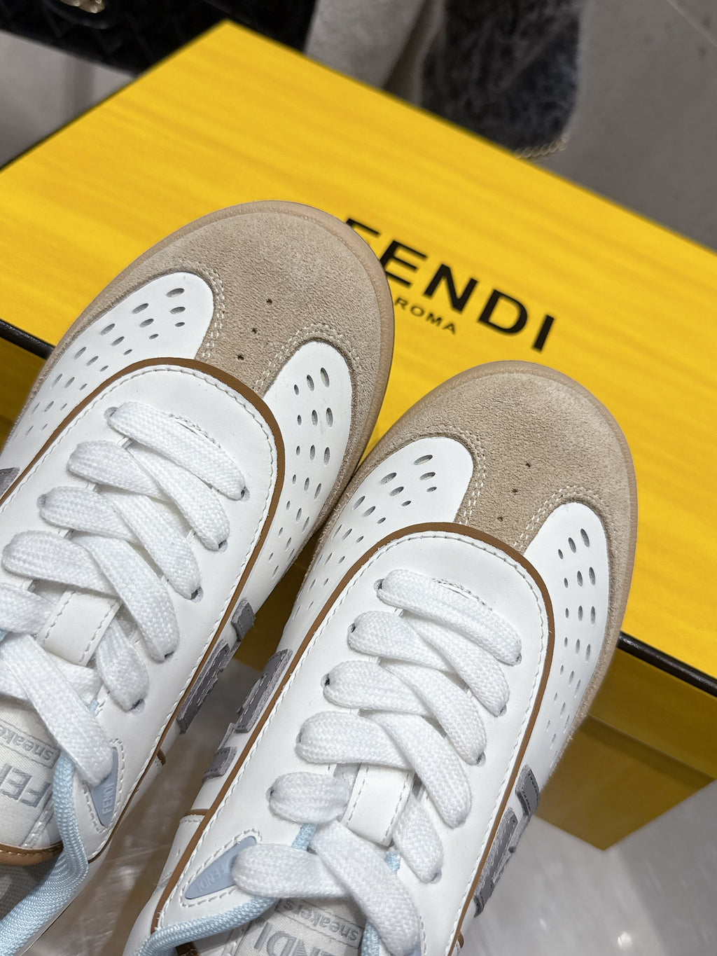 Fendi unisex sneakers, close-up of white perforated toe and lace front