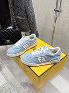 Light blue Fendi sneakers on box, white laces and large side F logo