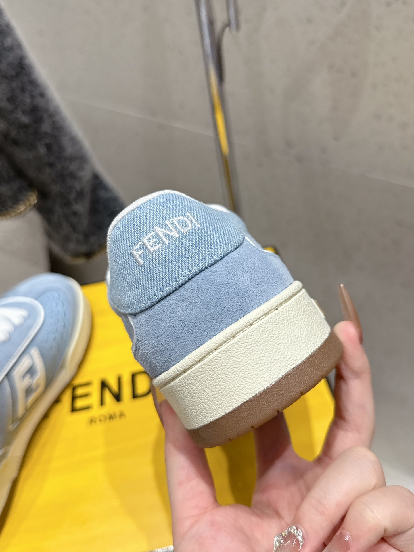 Light blue Fendi sneaker heel with FENDI logo patch and beige sole