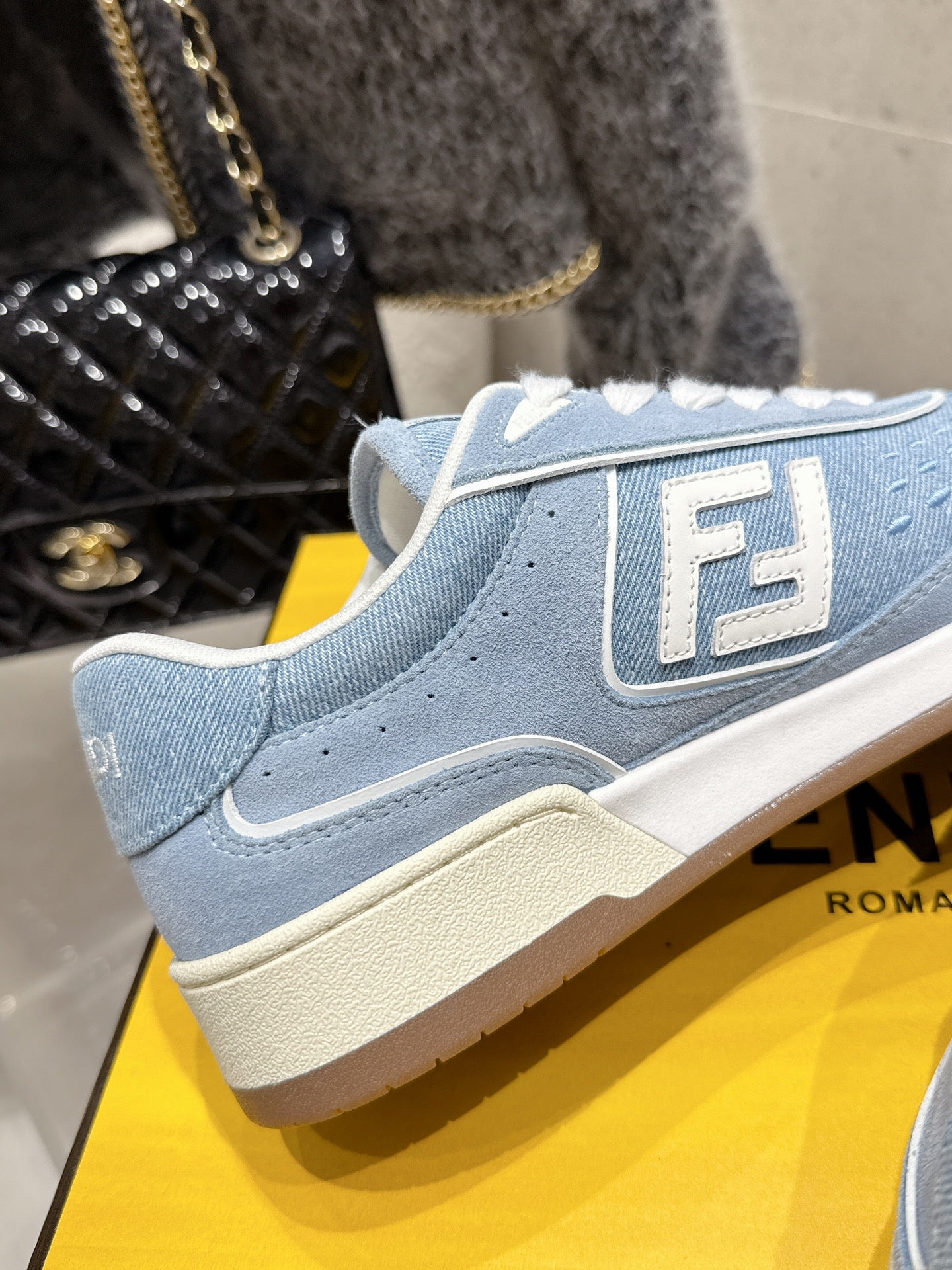 Light blue Fendi sneaker with white lace trim and large F side emblem