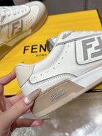White Fendi sneakers close-up, side FENDI logo and beige sole trim