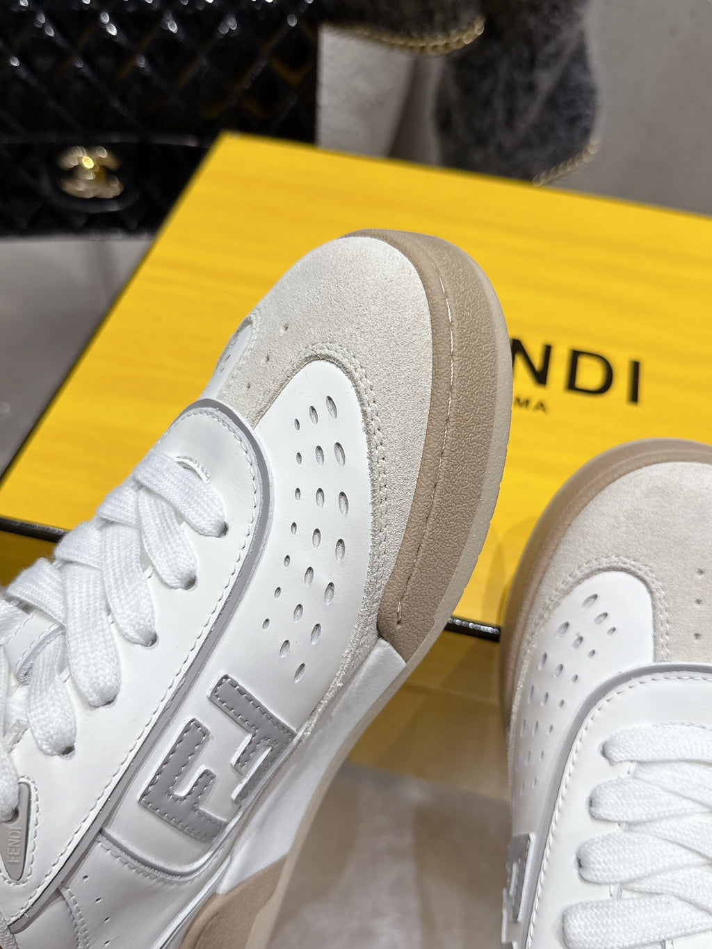 White sneaker heel and perforated panels, beige rubber sole detail