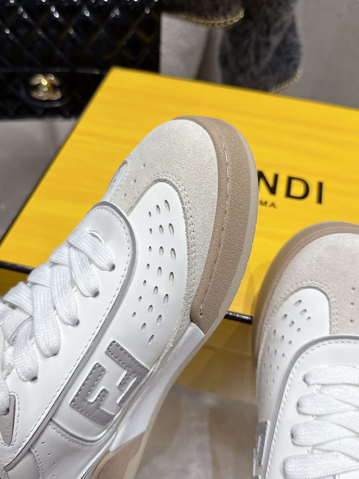 White sneaker heel and perforated panels, beige rubber sole detail
