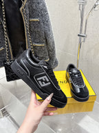 Fendi unisex sneakers, black with FF patch and lace-up front, shown in hand