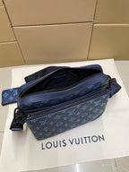Blue monogram crossbody bag with zipper top and adjustable shoulder strap