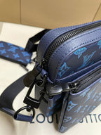 Blue monogram crossbody bag with black strap hardware and metal clasp