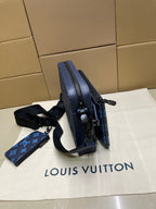 Blue monogram crossbody bag side view with shoulder strap and zipped top