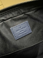 Blue fabric interior pocket with stitched label detail