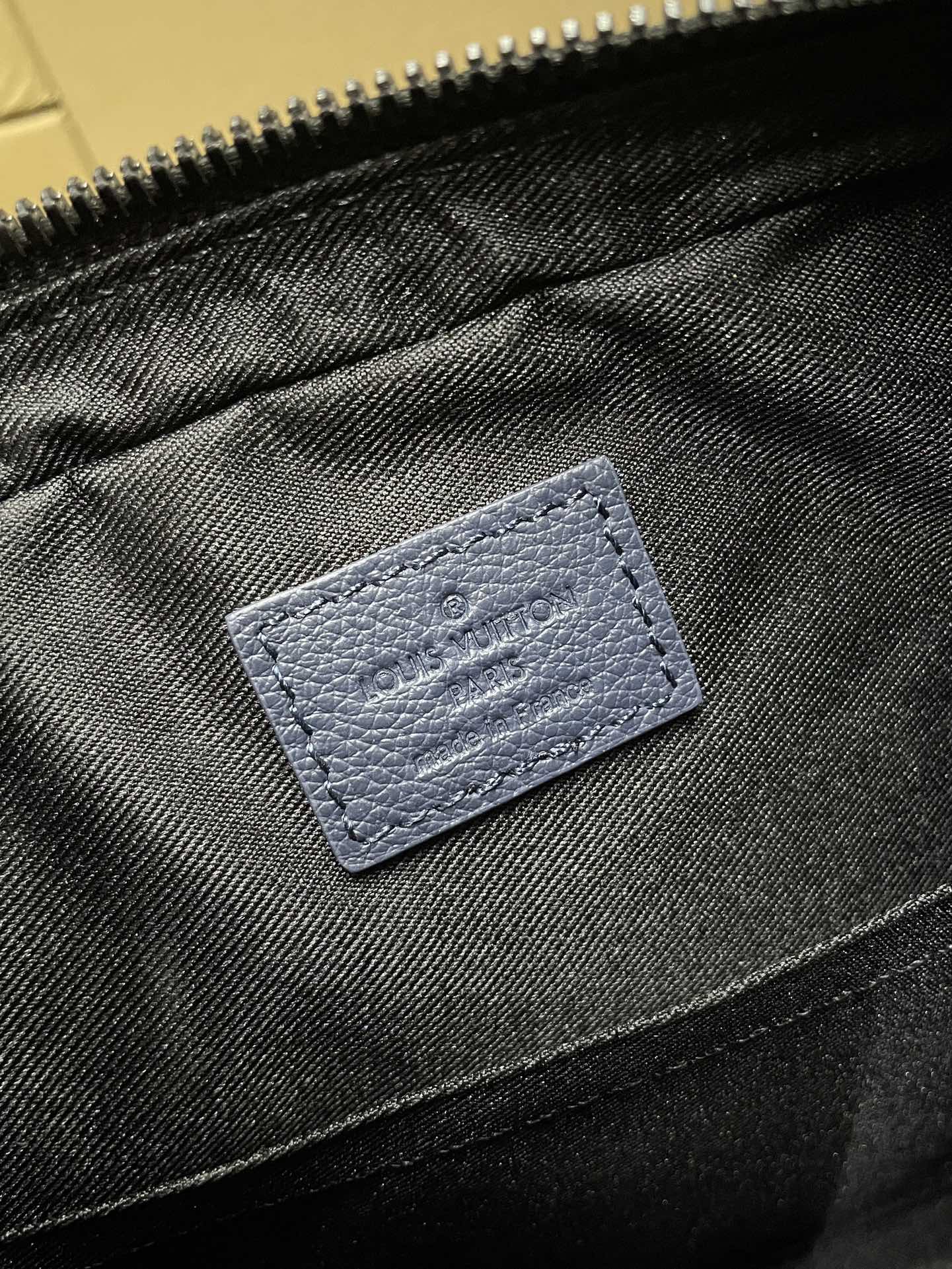 Blue fabric interior pocket with stitched label detail