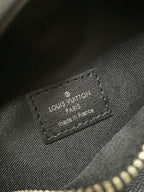 Louis Vuitton leather patch label on monogram waist bag, embossed text