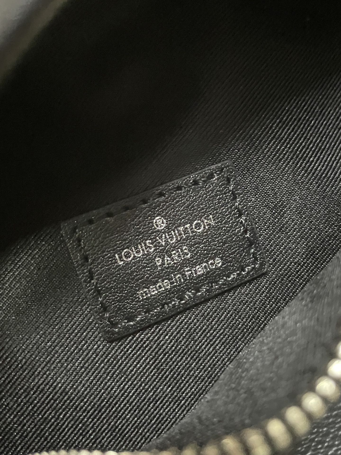 Louis Vuitton leather patch label on monogram waist bag, embossed text