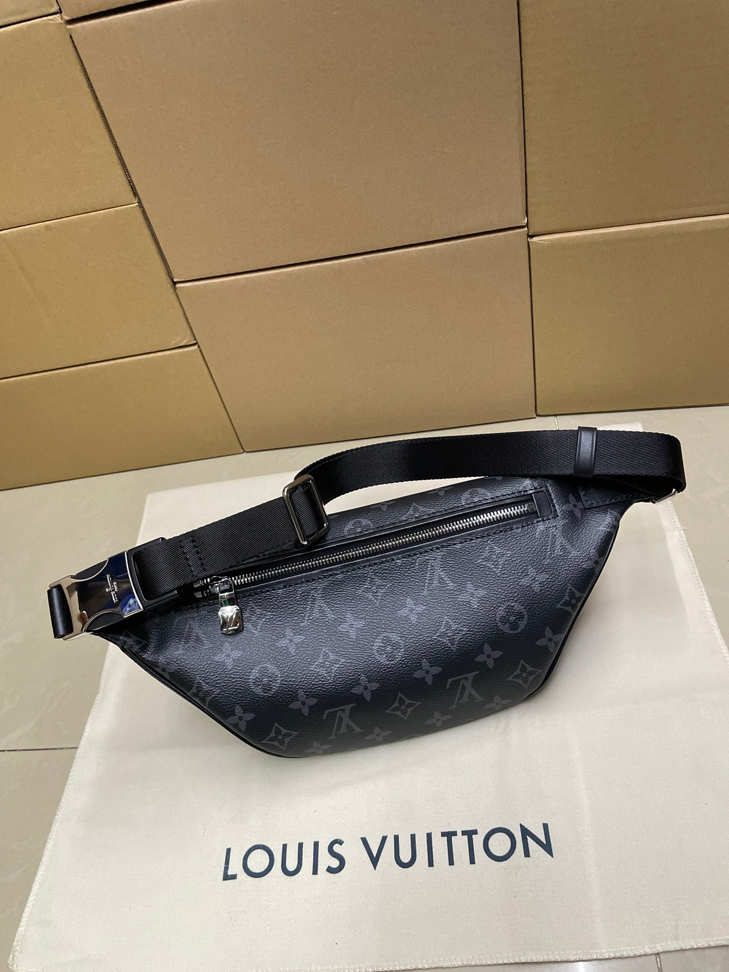 Louis Vuitton monogram waist bag in dark navy, side view with zipper and strap