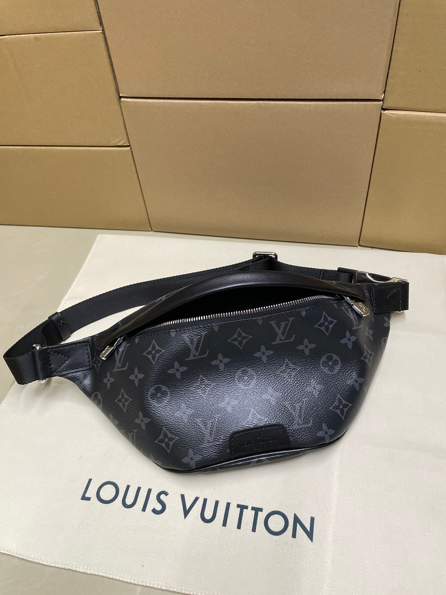 Louis Vuitton monogram waist bag in dark navy, front view with adjustable shoulder strap