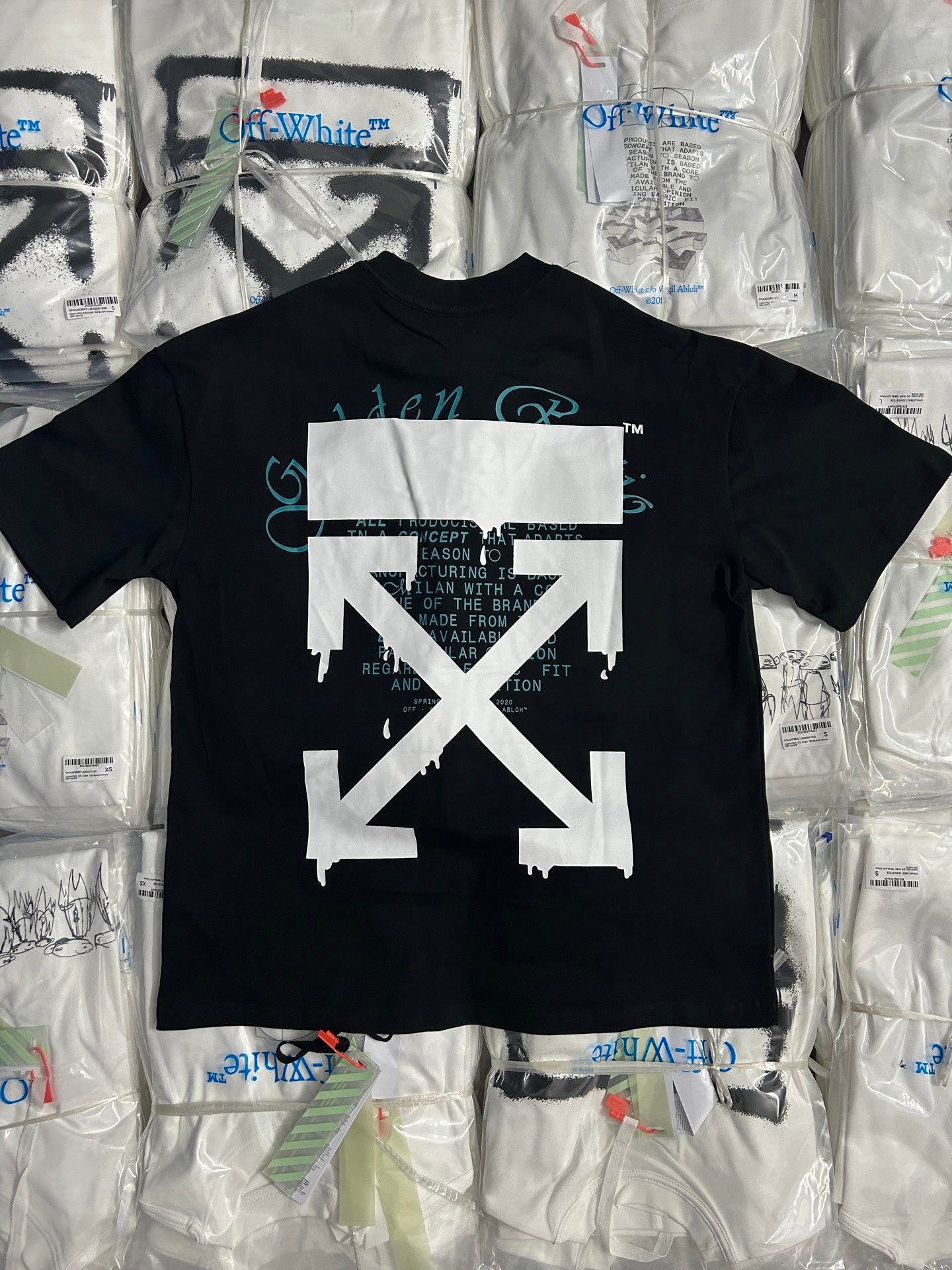 Black graphic T-shirt with large white X logo on the front.