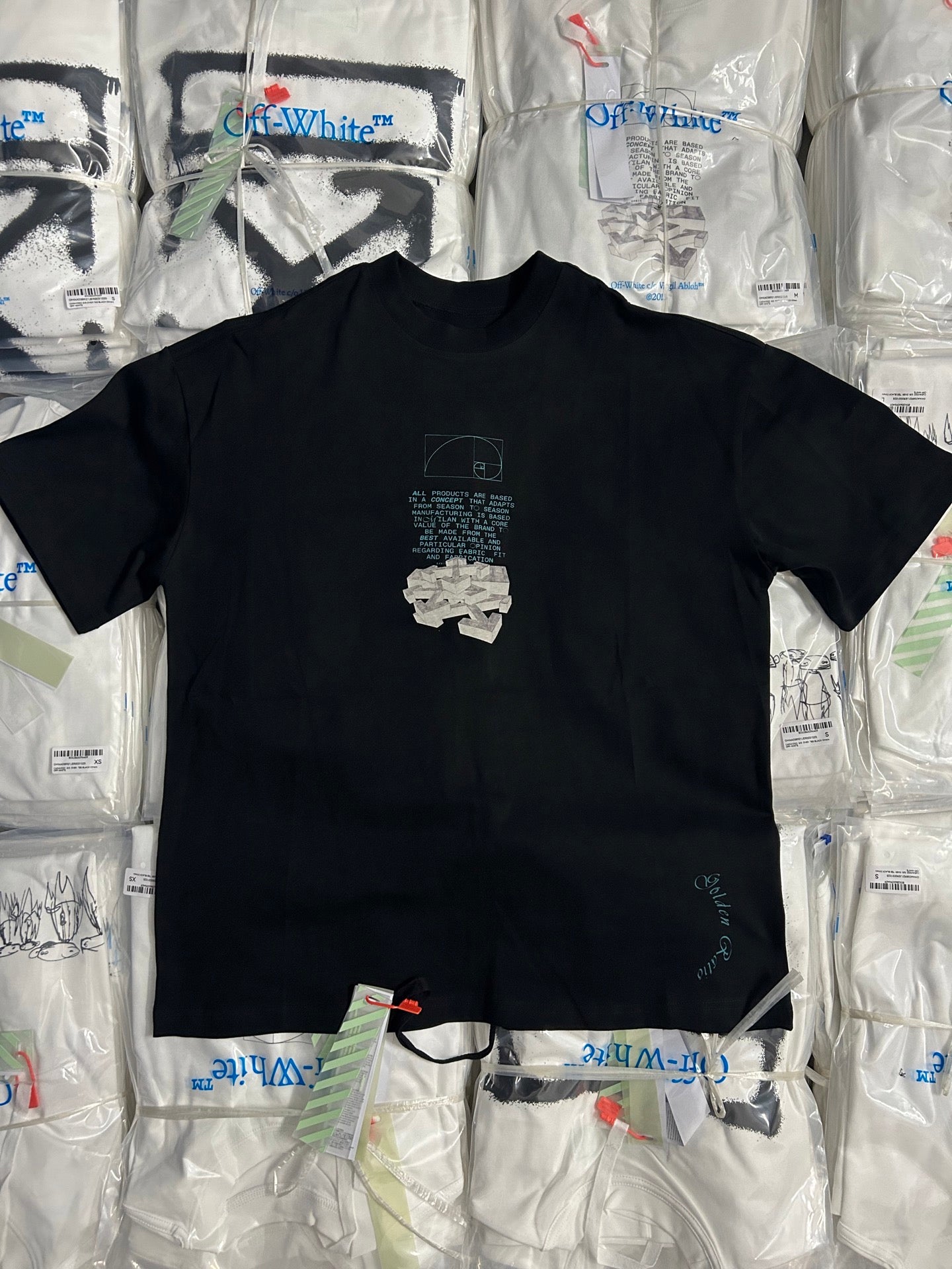 Black graphic T-shirt with large white X-style logo on the chest.