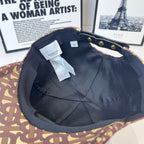 Burberry cap interior with black lining, Burberry tag, monogram trim