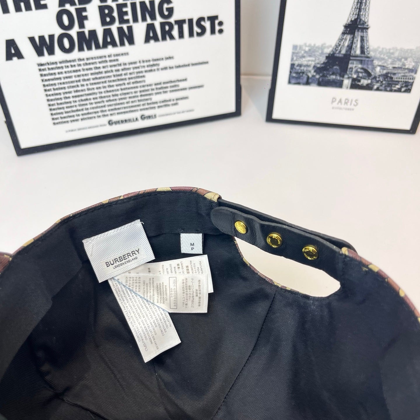 Burberry cap interior view with black lining and label, monogram trim