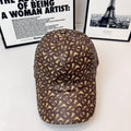 Burberry cap with brown-and-tan monogram pattern, curved brim