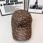 Burberry cap with brown-and-tan monogram pattern, curved brim