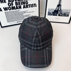 Burberry dark plaid cap with curved brim and stitched crown panels