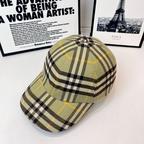 Burberry plaid cap in olive, black, and yellow checks, side view and crown button