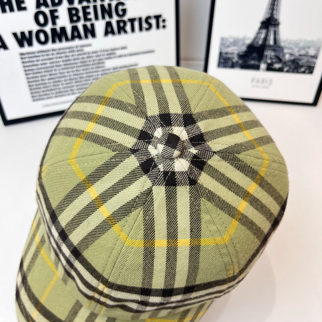 Burberry plaid cap showing crown button, olive, black, and yellow plaid pattern