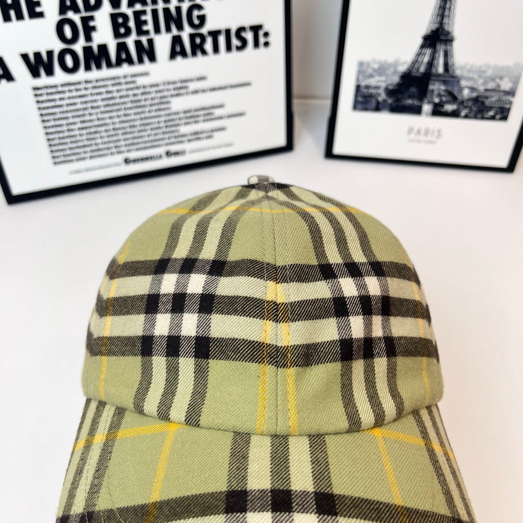Burberry plaid cap top view, olive plaid with black checks and yellow accents