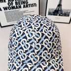 Burberry cap close-up with navy-and-white B logo pattern on the crown