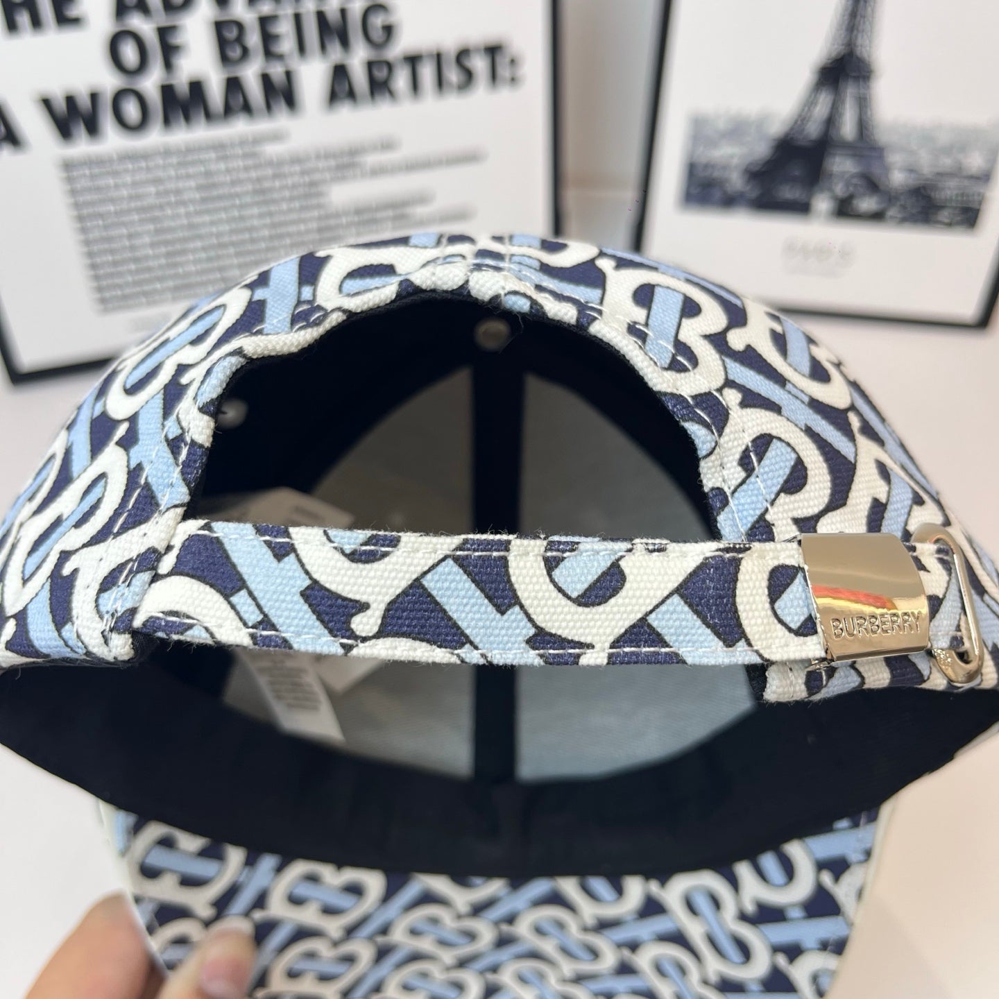 Burberry cap underside with navy-and-white B print, black interior and brim lining