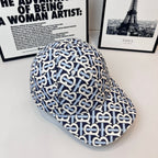Burberry cap in navy and white featuring all-over B logo pattern and curved brim
