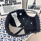 Burberry cap interior with black panels, top button hardware, and fabric brim trim