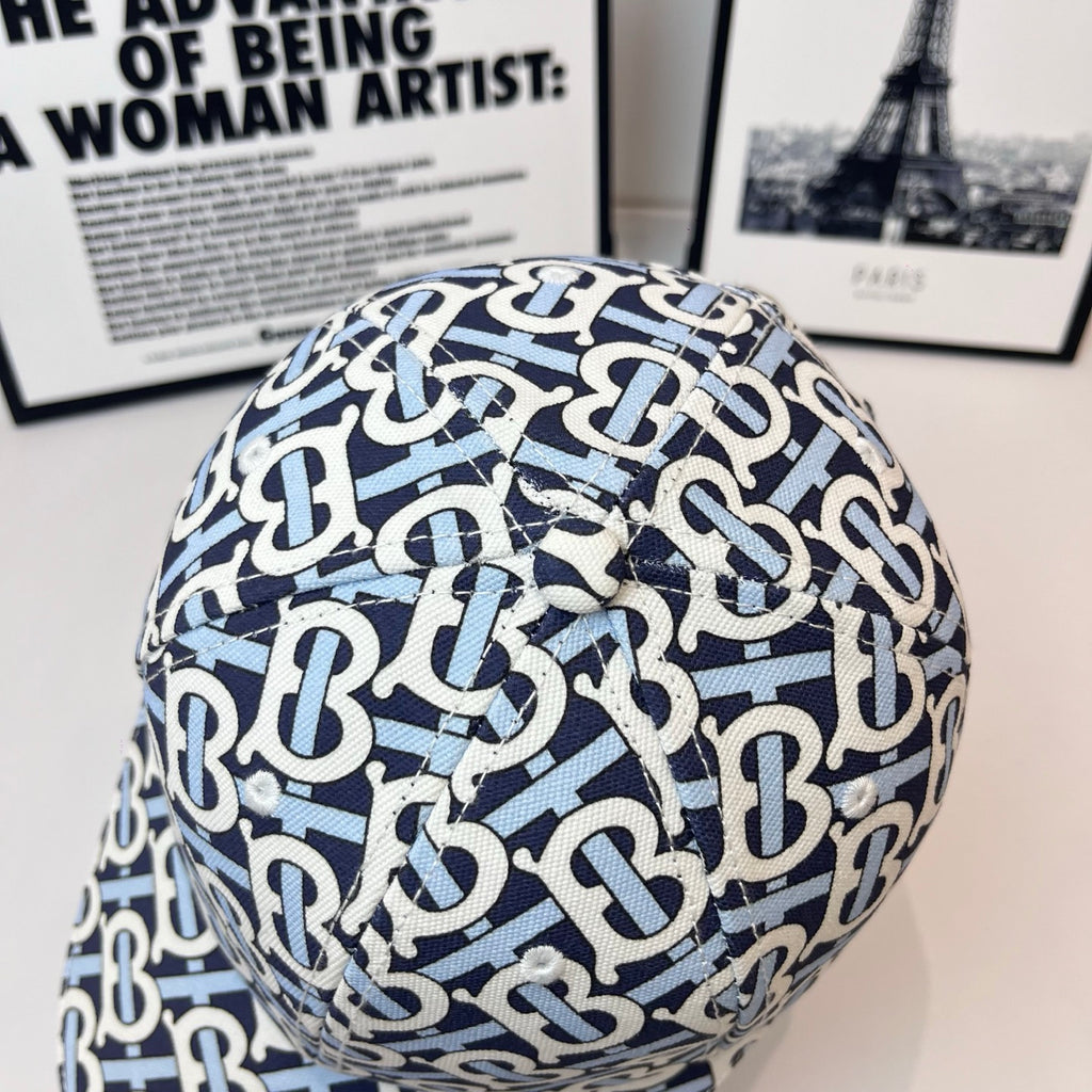Burberry cap close-up showing navy-and-white B logo pattern across the crown