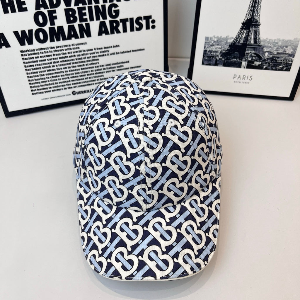 Burberry cap in navy and white with all-over B logo pattern and curved brim