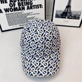 Burberry cap in navy and white with all-over B logo pattern and curved brim
