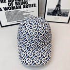 Burberry cap in navy and white with all-over B logo pattern and curved brim