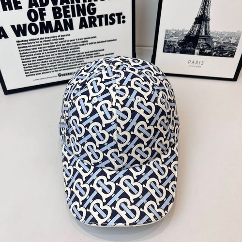 Burberry cap in navy and white with all-over B logo pattern and curved brim