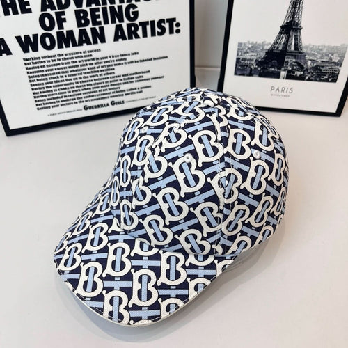 Burberry cap with navy-and-white B logo print and curved brim, side view