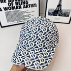 Burberry cap with navy-and-white B logo pattern, curved brim and side profile