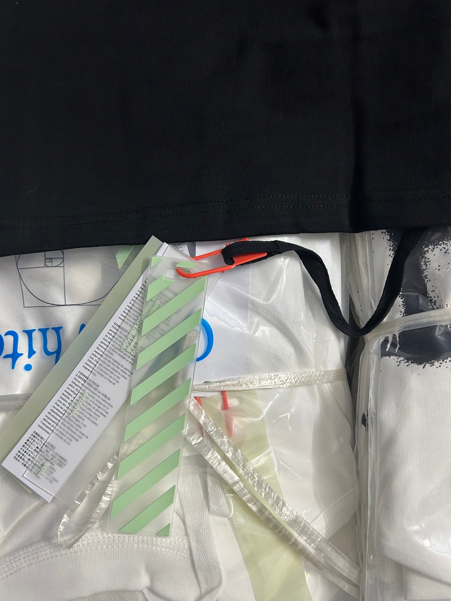 Black T-shirt shoulder and collar view with interior hang tag visible