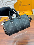 Men's Louis Vuitton monogram bag held in hand, dark gray with zip top