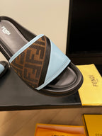 Blue slide sandal detail: brown FF-logo strap with light blue trim on black footbed