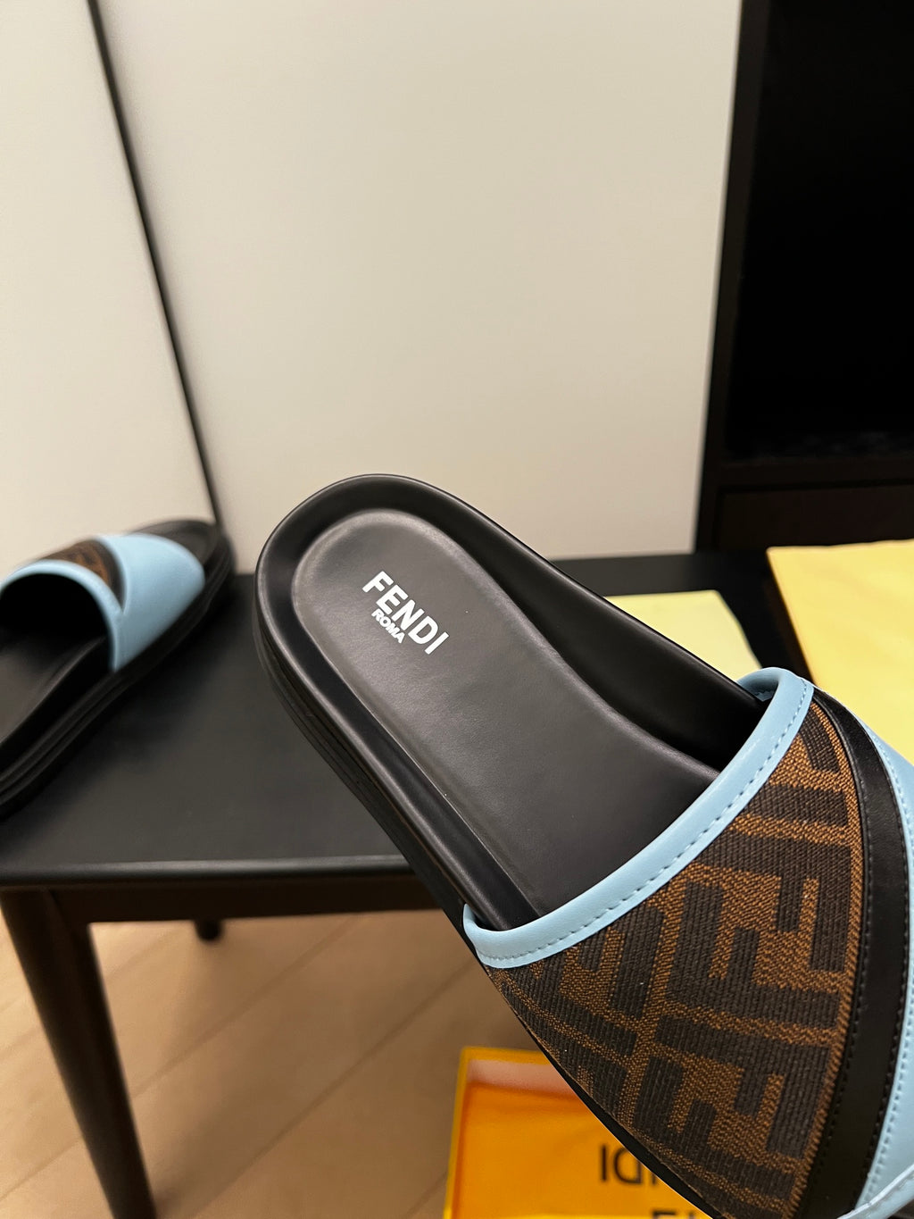 Blue slide sandal top view with brown FF-logo strap and black footbed, FENDI
