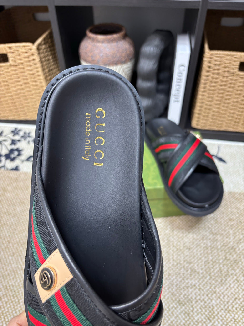 Gucci black slide sandals footbed view, gold logo text on insole