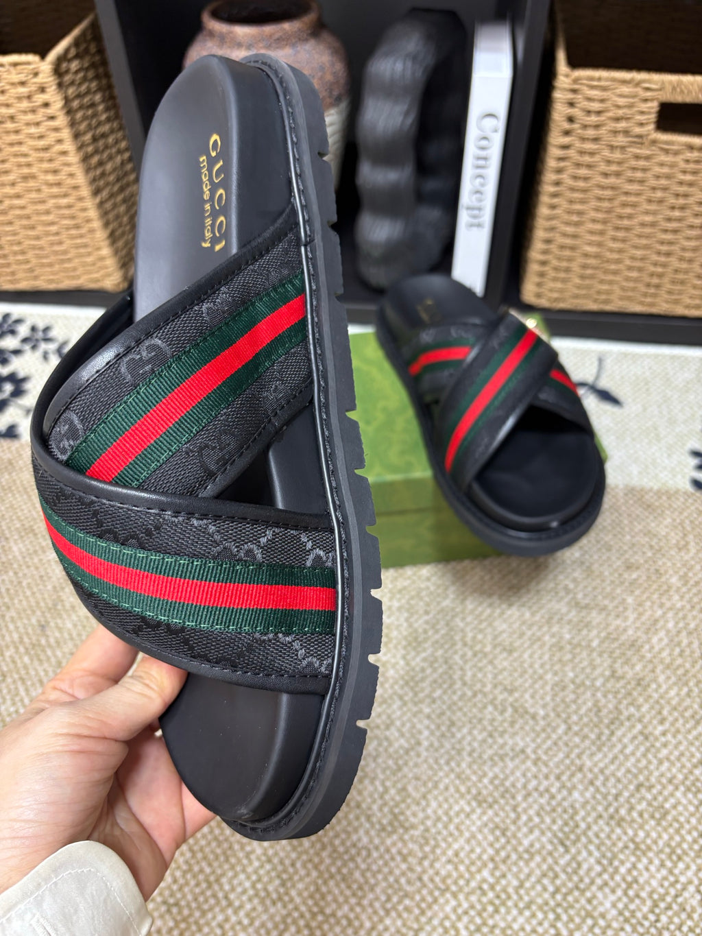 Gucci black slide sandals close-up, green red web stripe and gold buckle