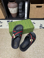 Gucci black slide sandals on green box, red green web strap with metal badge
