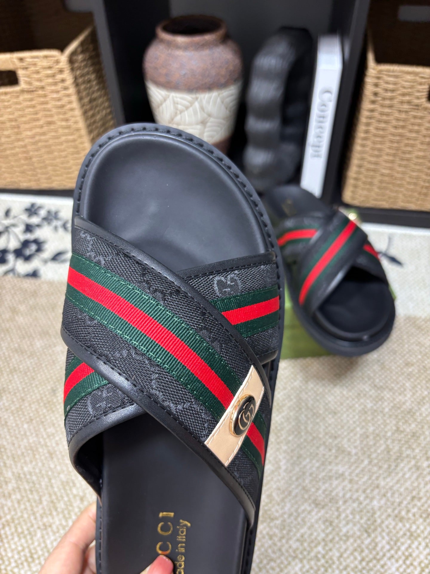Gucci black slide sandals front view, textured upper with green red web band