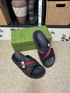 Gucci black slide sandals, two views, green red web stripe across strap