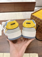 Back view of low-top sneakers, white with yellow heel tabs, blue rubber soles