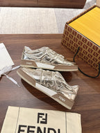 Metallic low-top sneakers with white laces and Fendi branding on tongue and side