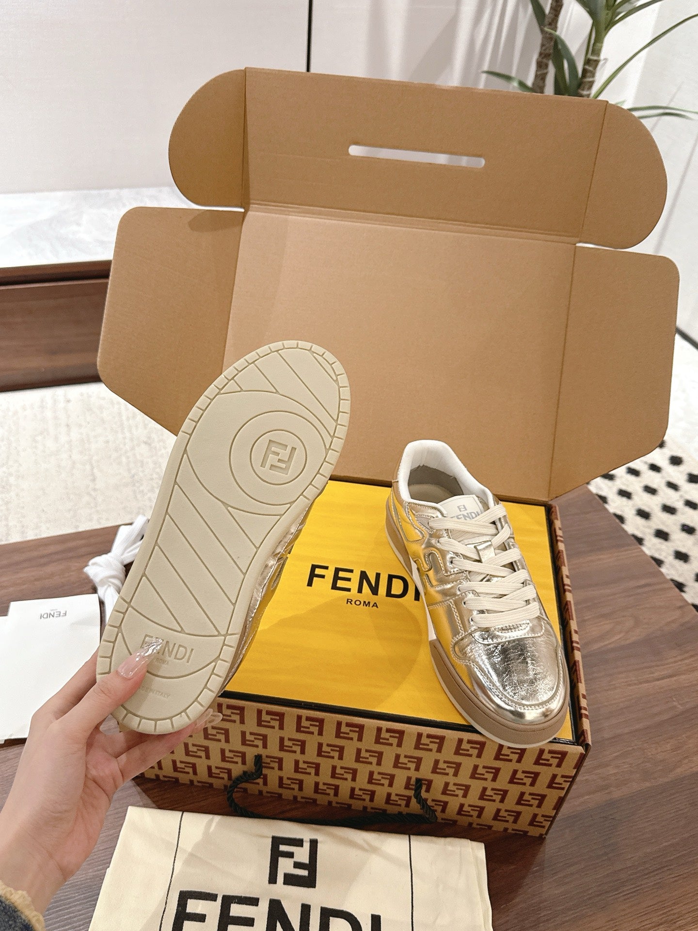 Metallic low-top sneakers with white laces, front and outsole views, Fendi branding